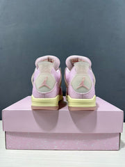 Rear view showing the Jordan heel logo, pink upper, pale yellow midsole, and pink shoebox.