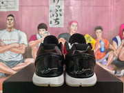 Rear view showing the glossy black heel panels, white heel markings, and white midsoles.