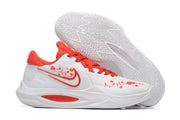 White basketball shoe with bright red accents and red decorative graphics.