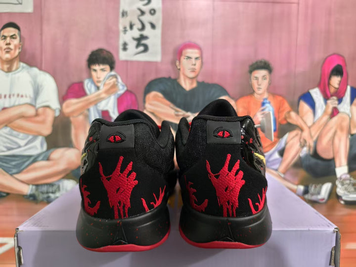 Rear view of black Nike sneakers showing red heel graphics, black midsoles, and red outsole edges on a shoe box.