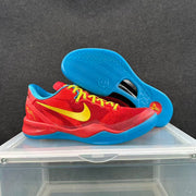 Angled view of the red and blue Nike basketball sneakers, including the patterned blue outsole and yellow laces.