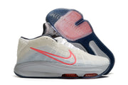 Side view of light gray Nike GT Hustle 3 with coral accents and visible cushioning units.