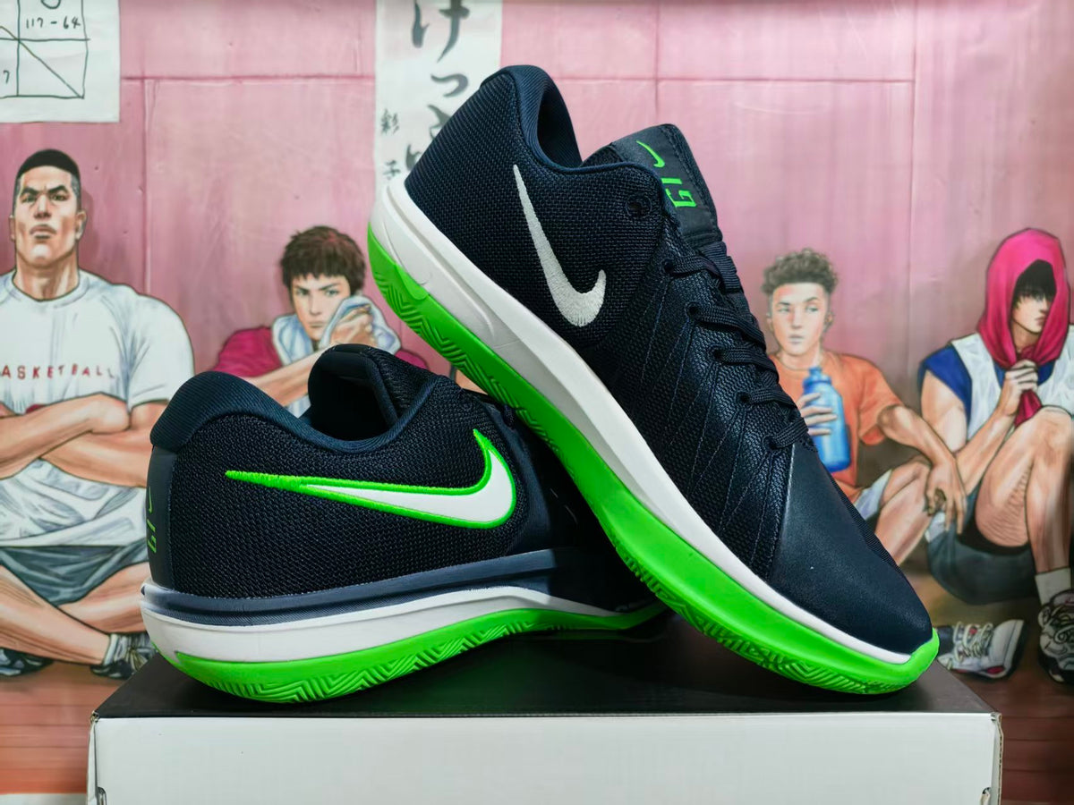 Pair of black Nike Kyrie basketball shoes with white Swooshes and bright green outsole details.