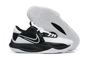 Black and white low-top basketball shoe with a patterned white outsole.