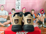 Rear view of khaki and black sneakers showing heel patches and chunky black soles.