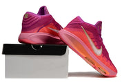 Pink and purple Nike GT Hustle 3 shoes posed on and beside a shoe box.