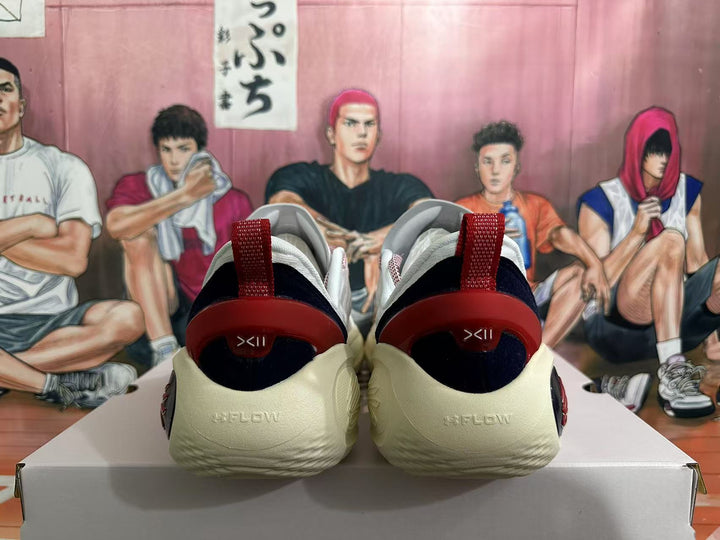 Rear view of white basketball shoes with red heel pull tabs, black heel details, and a light-colored sole