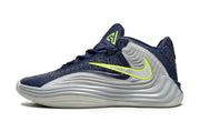Side profile of a navy and gray Nike Giannis Immortality 7 basketball shoe