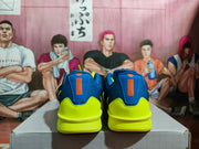 Rear view showing blue heel collars, bright yellow heel panels, and orange vertical accents.