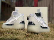 Rear view showing the heel panels, black heel accents, and patterned uppers