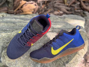Top and side view of blue and red Kobe 11 sneakers with dark laces and yellow Swooshes