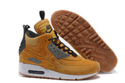 Side and outsole view of tan Nike Air Max 90 high-top shoes with brown tread