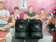 Rear view of black Nike basketball sneakers showing A'ja heel branding and a textured black upper.