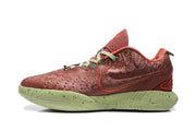 Outer side profile showing the orange-red patterned upper, outlined swoosh, padded collar, and green speckled sole.