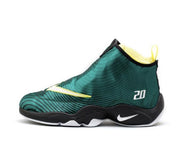 Green and black Nike Payton basketball sneaker with yellow lining, a white Swoosh, and the number 20 on the side.