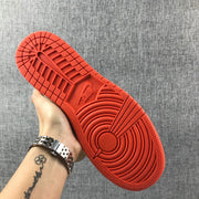Close-up of the orange outsole with circular and segmented traction patterns.