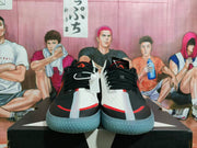 Front view showing black laces, white panels, and red accents