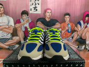 Front view of blue and light gray Nike sneakers with neon green laces