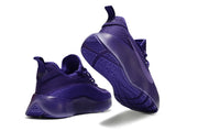 Purple sneaker pair showing the heel and patterned outsole.