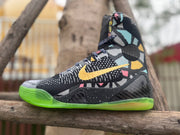 Side view of a Nike Kobe 9 All-Star high-top with gold-colored Swoosh detail and multicolor pattern