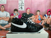 Side profile of a black low-top sneaker with white side branding, scorpion-pattern detailing, and reflective accents.