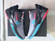 Pair of Nike Kobe 6 shoes arranged over a dark shoebox.