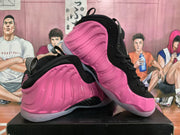 Two pink and black high-top basketball shoes displayed at an angled side view.