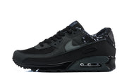 Side view of a black Nike Air Max 90 sneaker with a dark grey Swoosh and patterned heel lining.