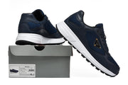Navy mesh-panel sneakers displayed on a box with a visible Prada label.