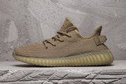 Side profile highlighting the low-top silhouette, heel pull tab and ribbed outsole.
