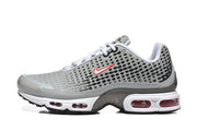 Side view of grey Nike Air Max Plus VIII sneakers with patterned uppers, red Swoosh accents, and visible sole cushioning.