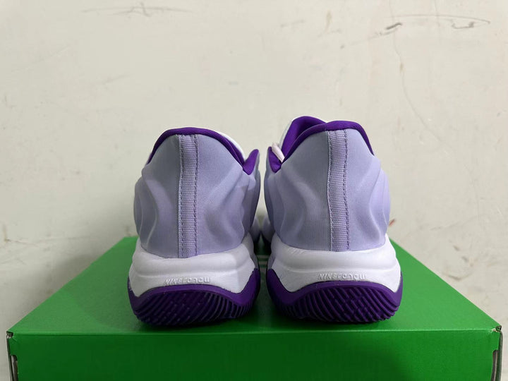 Rear view of lavender and purple Nike basketball sneakers with white midsoles and purple outsoles