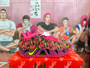Side profile of the Nike basketball sneaker with a yellow Swoosh, patterned upper, pink laces, and visible ZoomX marking.