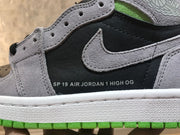 Close-up of the grey Swoosh, black side panel and printed Air Jordan 1 High OG text.