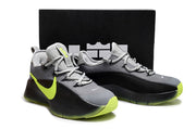 Smoke grey and black sneakers with neon yellow-green outsole and side accents.