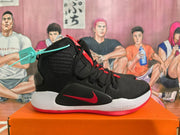 Side view of a black Nike basketball shoe with a red swoosh, white midsole, and red outsole.