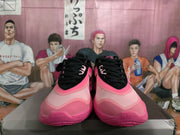 Front view of black and pink Nike basketball sneakers displayed on a box.