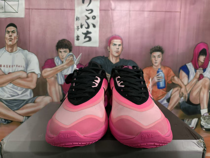 Front view of black and pink Nike basketball sneakers displayed on a box.
