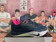 Side view of a dark navy Nike basketball sneaker showing dark laces, pink lining, a white midsole, and pale green outsole detailing.