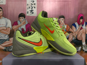 Angled view of the neon green and orange Nike basketball sneakers displayed together, showing the side branding and outsole.