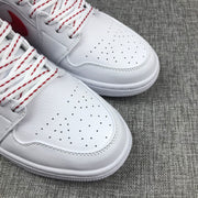Close-up of the perforated white toe box and red-accented laces.