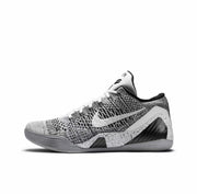 Side view of a grey-and-black Nike Kobe 9 basketball shoe with a textured upper, white Swoosh, and speckled midsole panels.