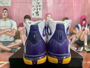 Rear view showing the purple heel structure, white collar, and yellow outsole.