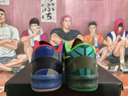 Rear view of the mismatched sneakers, showing contrasting blue and green heel sections, padded collars, and speckled midsoles.
