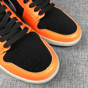 Close-up of the black perforated toe box and orange toe overlay.