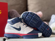 Pair of high-top sneakers showing the navy outsole with segmented herringbone-style tread.