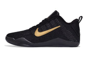 Black low-cut basketball shoe with gold-colored side accent