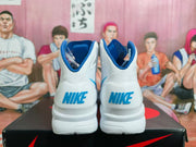 Rear view of white Nike high-top shoes with blue collars and heel logos