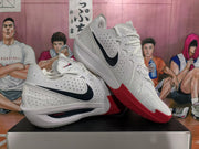 Angled view of the pair of white and red Nike sneakers displaying the black Swoosh, perforated upper, white midsole, and red outsole.