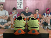 Rear view of lime-green Nike basketball shoes with orange detailing